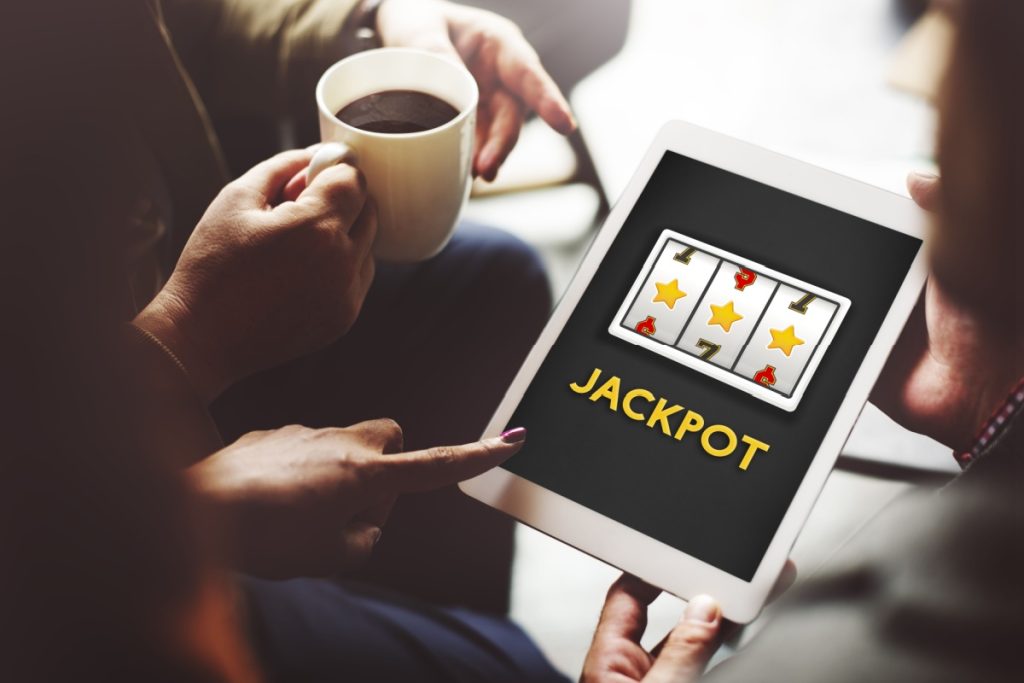 femeie tinand in mana o tableta pe care ruleaza un joc de slot