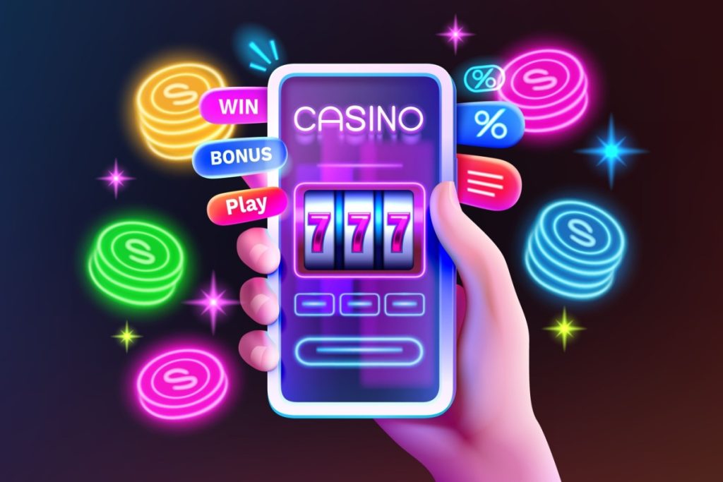 mana unei persoane tinand un telefon mobil pe care ruleaza o aplicatie de cazino online, cu jetoane in culori neon in jur